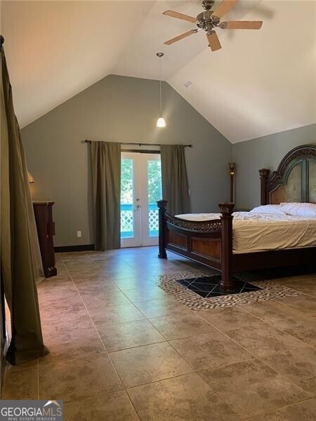 tiled bedroom featuring vaulted ceiling, ceiling fan, french doors, and access to exterior