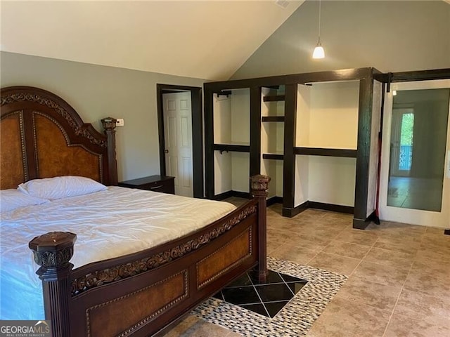 tiled bedroom with lofted ceiling