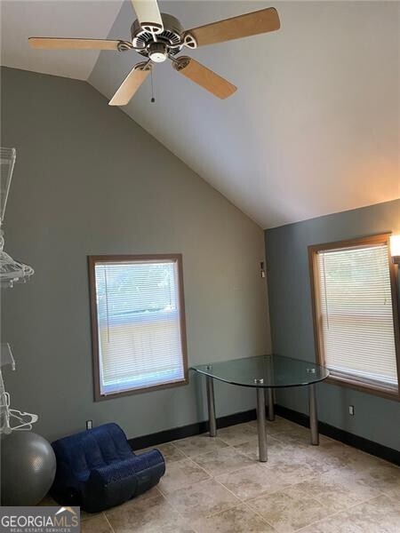 interior space with vaulted ceiling and ceiling fan