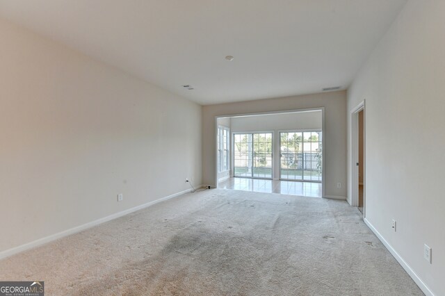 unfurnished room featuring light colored carpet