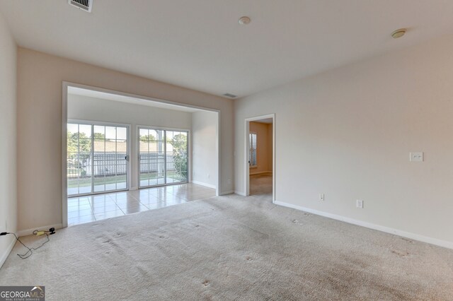 unfurnished room featuring light colored carpet