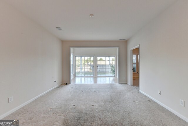 spare room with light colored carpet