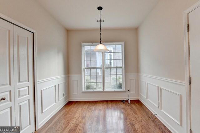 unfurnished dining area with light wood-type flooring