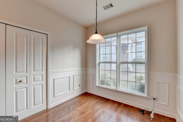 unfurnished dining area with wood-type flooring