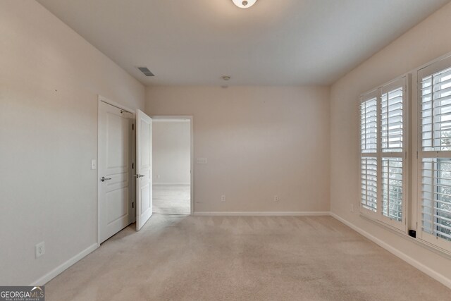 empty room featuring light colored carpet