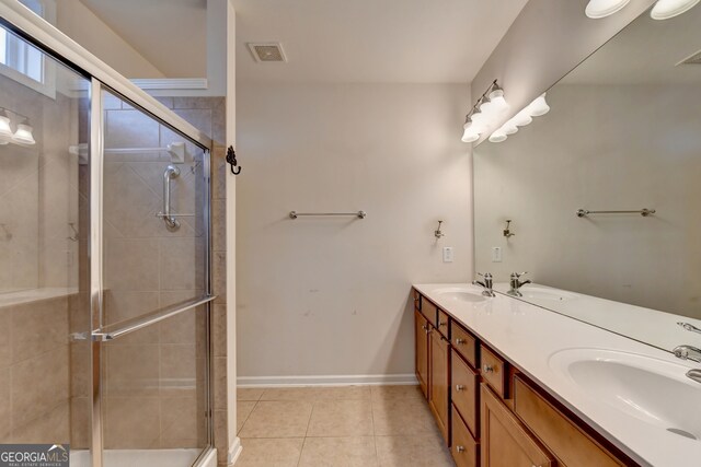 bathroom featuring walk in shower, vanity, and tile patterned flooring