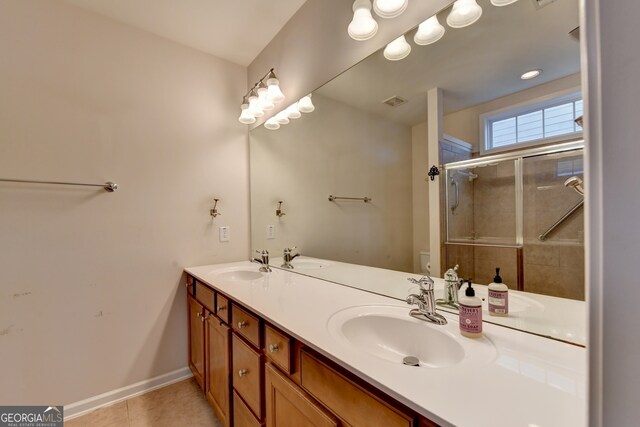 bathroom featuring vanity, toilet, tile patterned flooring, and a shower with door