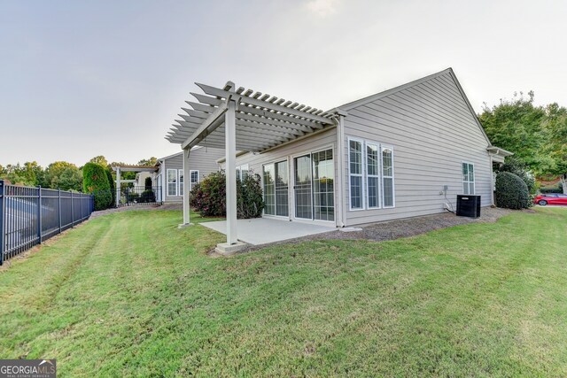 rear view of house featuring a pergola, a yard, a patio area, and central air condition unit