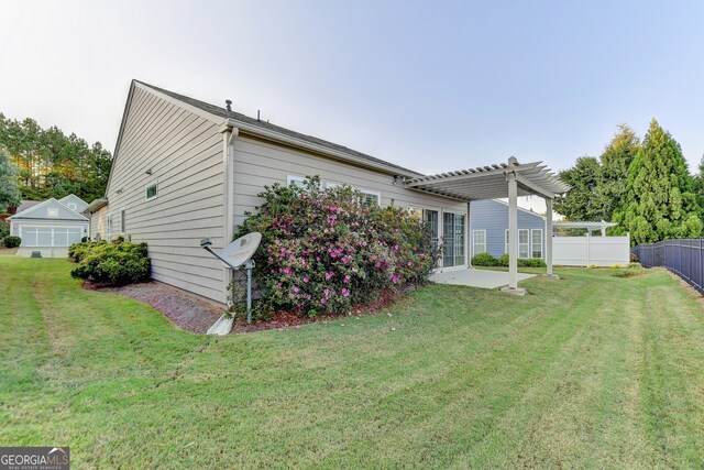 rear view of house with a pergola, a patio area, and a lawn