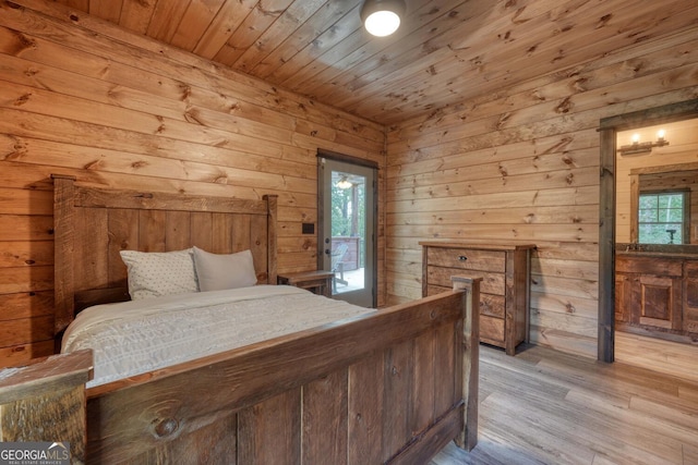 bedroom featuring wooden walls, light wood-type flooring, and wooden ceiling