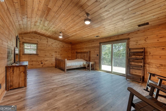 unfurnished bedroom with wood ceiling, wood-type flooring, vaulted ceiling, and access to exterior