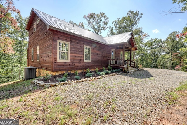 view of home's exterior with cooling unit and covered porch