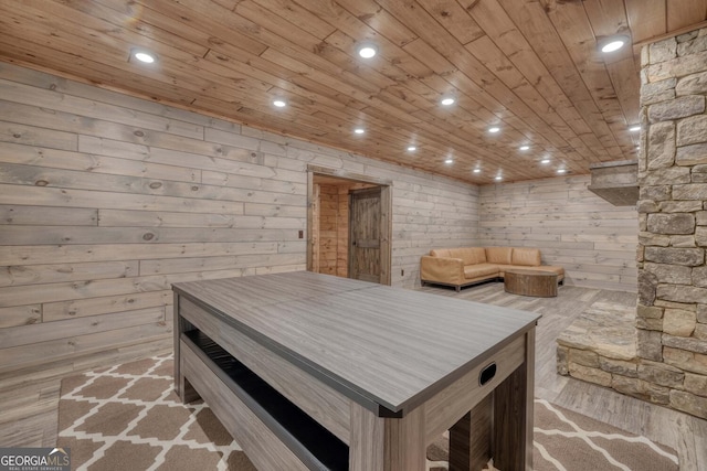 miscellaneous room featuring wooden ceiling, wood walls, and light hardwood / wood-style flooring