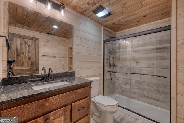 bathroom featuring vanity, wooden walls, hardwood / wood-style floors, and toilet