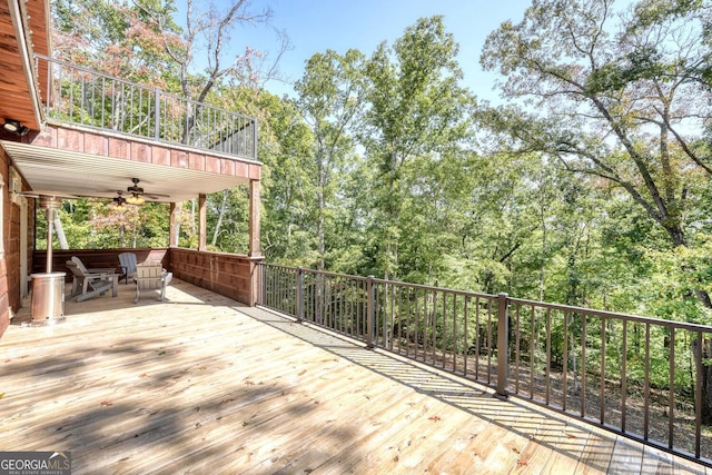 wooden terrace featuring ceiling fan