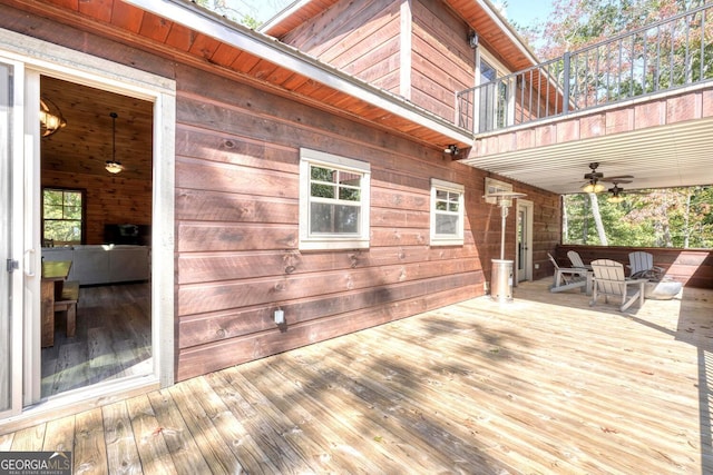 wooden deck featuring ceiling fan