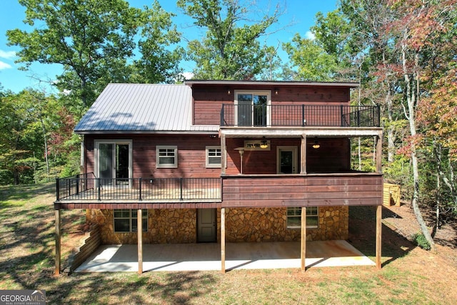 rear view of property with a balcony and a patio area