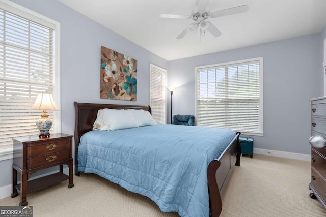 bedroom with ceiling fan and light colored carpet