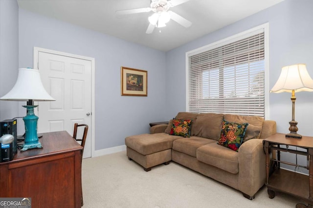 carpeted living room with ceiling fan