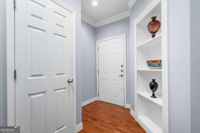 interior space featuring hardwood / wood-style flooring and crown molding