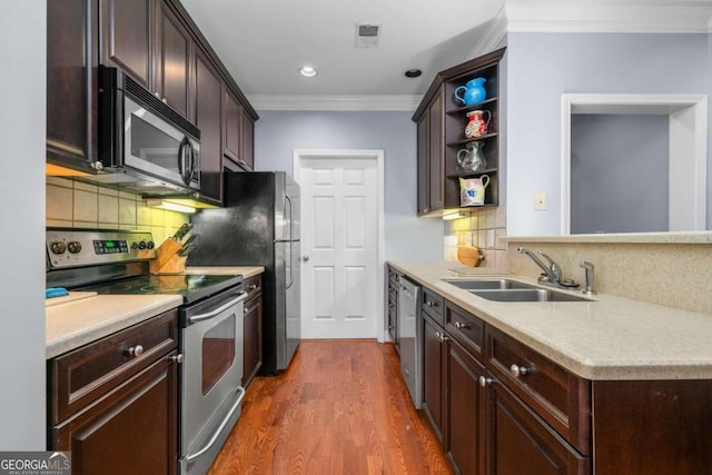 kitchen with appliances with stainless steel finishes, dark hardwood / wood-style floors, sink, and decorative backsplash