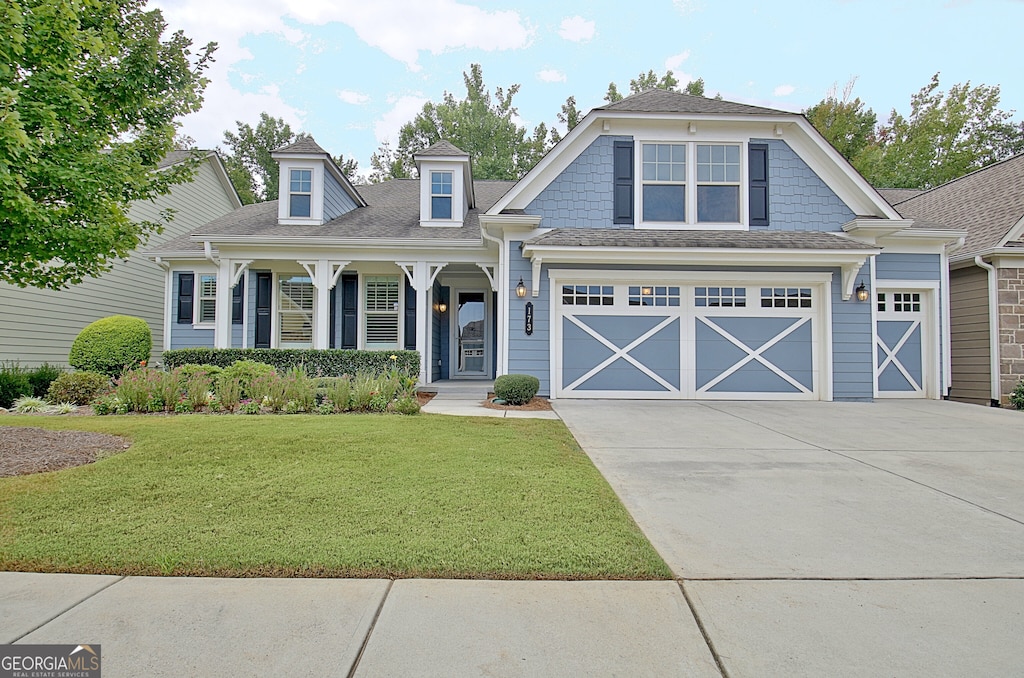 view of front facade with a garage and a front lawn