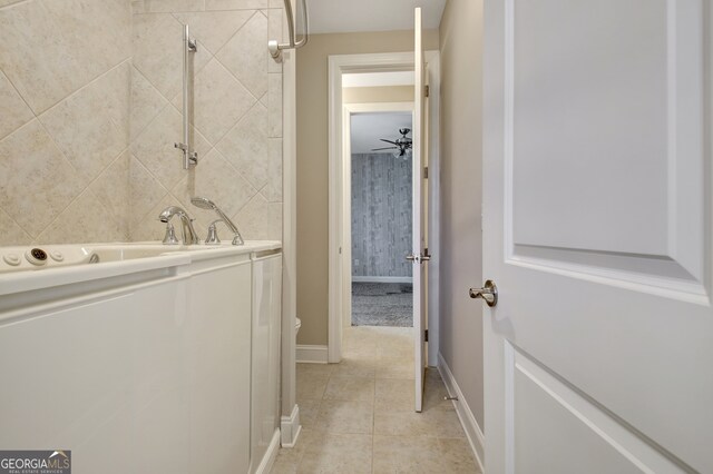 interior space with tile patterned flooring, toilet, and ceiling fan