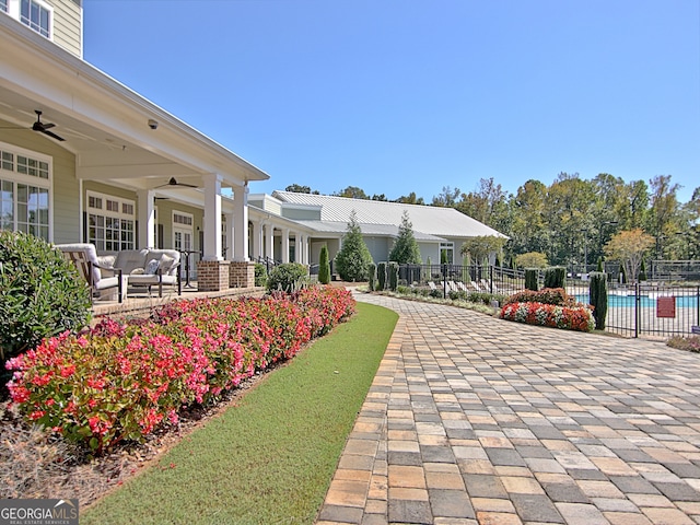 surrounding community with a patio, a pool, and an outdoor hangout area