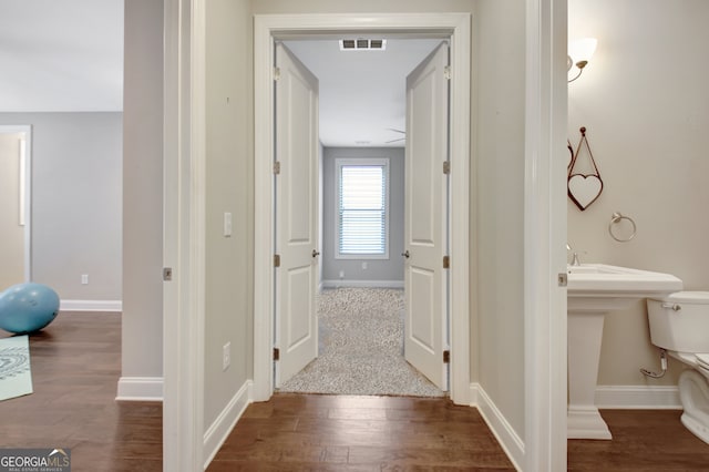 hall with hardwood / wood-style floors