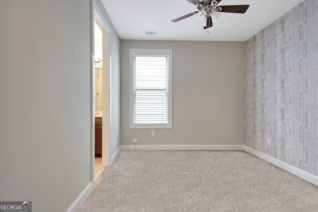 unfurnished room featuring ceiling fan and light colored carpet