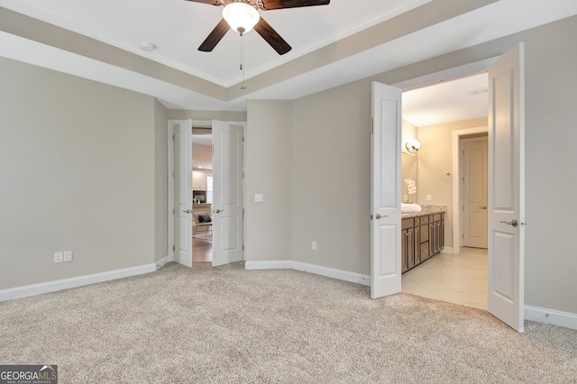 unfurnished bedroom with ornamental molding, connected bathroom, ceiling fan, and light colored carpet