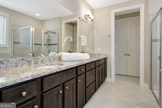 bathroom featuring tile patterned floors, walk in shower, and vanity