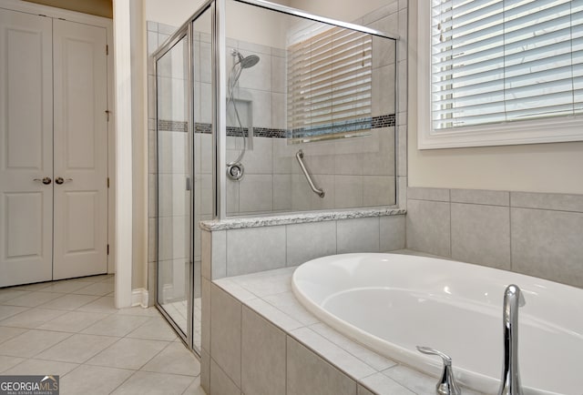 bathroom with separate shower and tub and tile patterned floors