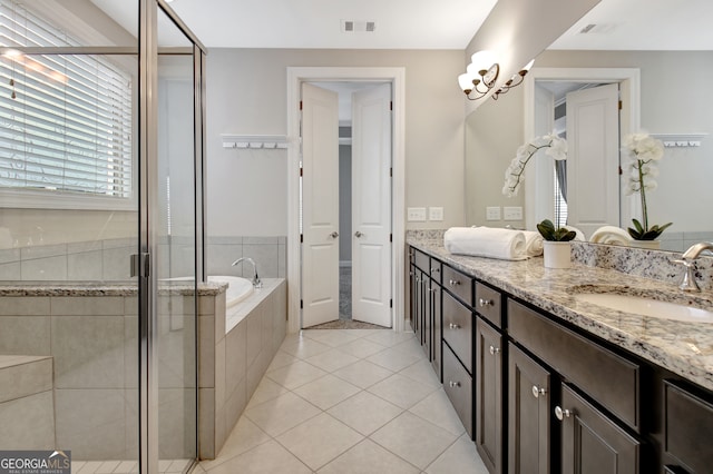 bathroom featuring vanity, plus walk in shower, and tile patterned floors