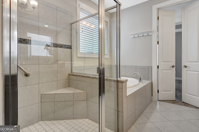 bathroom featuring independent shower and bath and tile patterned flooring