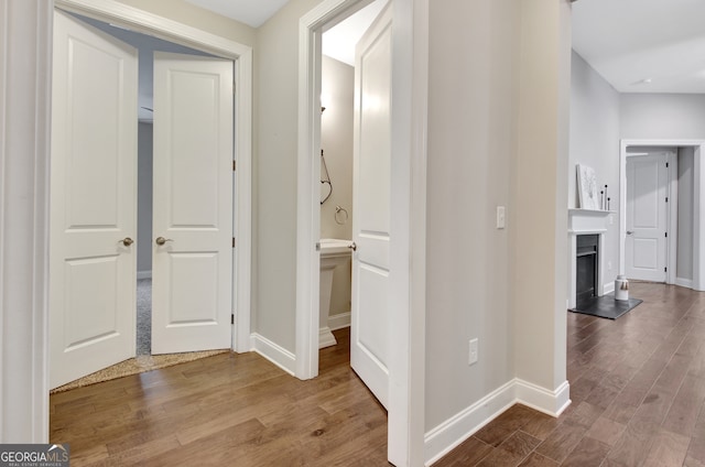 corridor with wood-type flooring