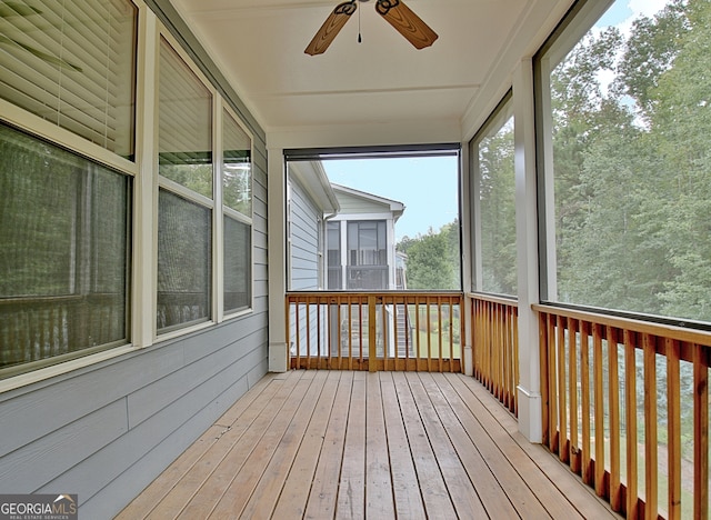 unfurnished sunroom featuring ceiling fan