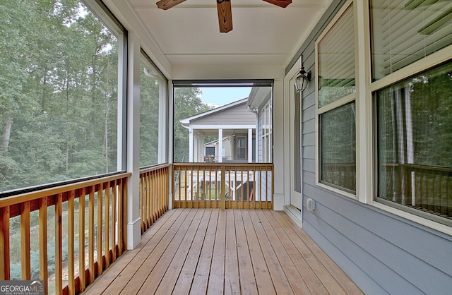 unfurnished sunroom featuring ceiling fan and plenty of natural light