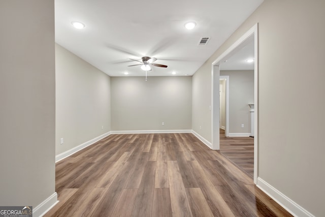 unfurnished room with ceiling fan and dark hardwood / wood-style floors