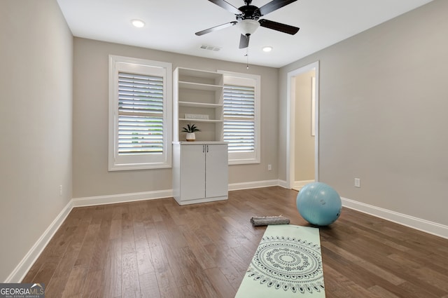 exercise area with ceiling fan and hardwood / wood-style flooring