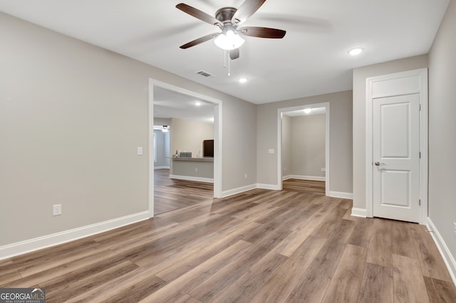 spare room with light hardwood / wood-style flooring and ceiling fan