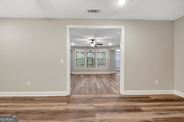 empty room with hardwood / wood-style floors and ceiling fan