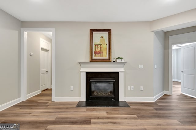 unfurnished living room with hardwood / wood-style flooring