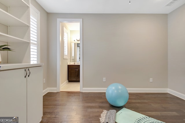 exercise room featuring dark hardwood / wood-style floors