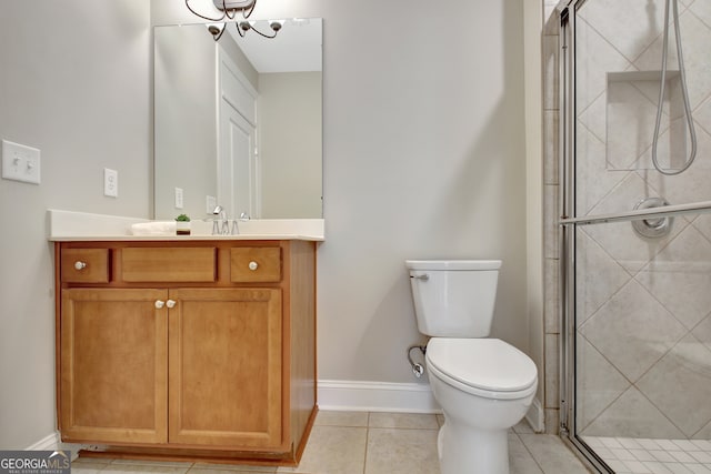 bathroom featuring tile patterned floors, walk in shower, vanity, and toilet