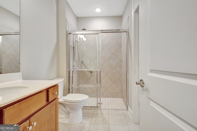 bathroom featuring vanity, tile patterned flooring, toilet, and an enclosed shower