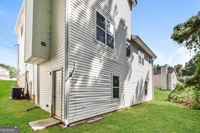 view of property exterior featuring cooling unit and a yard