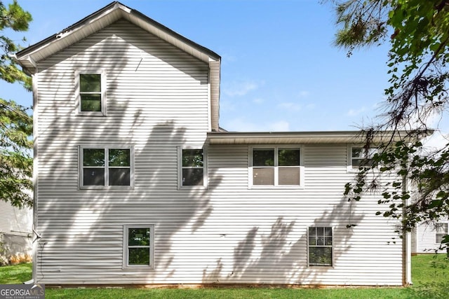 view of side of home featuring a lawn