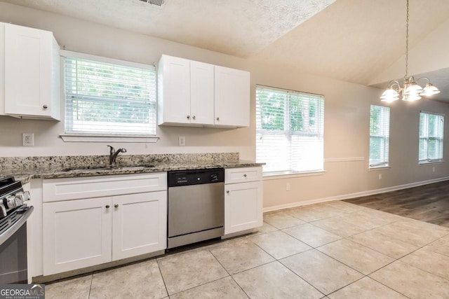 kitchen with white cabinets, lofted ceiling, appliances with stainless steel finishes, and sink