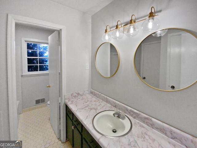 bathroom featuring tile patterned flooring and vanity